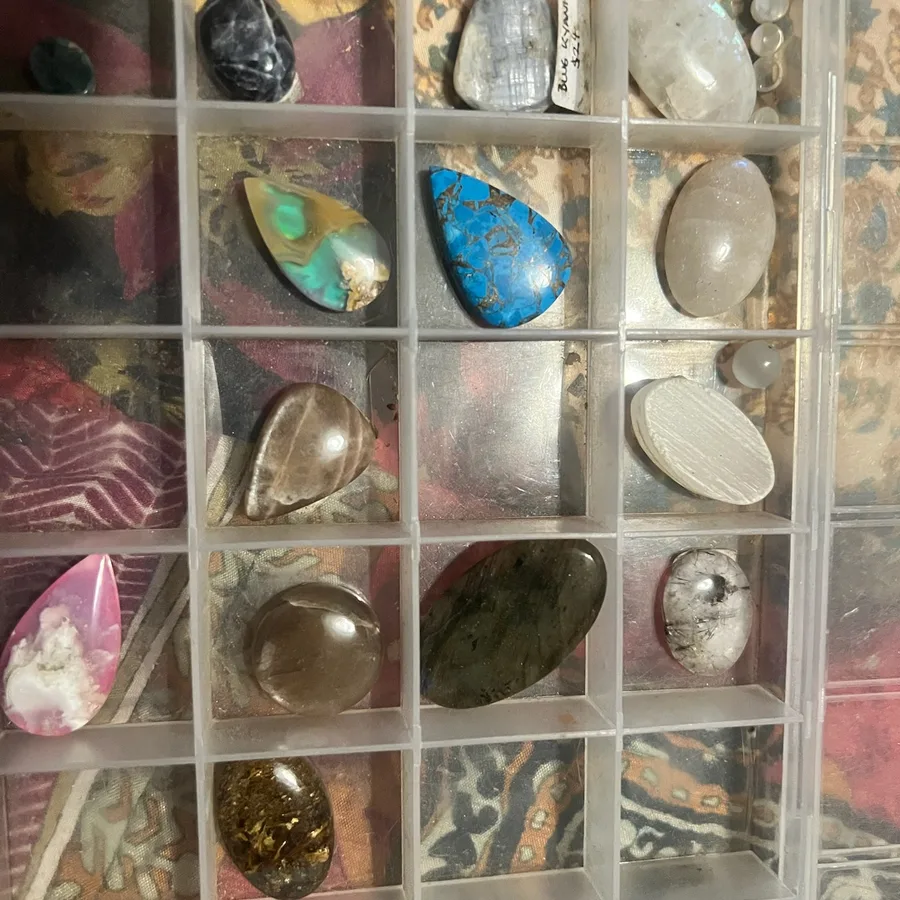 Stones and cabochons organised in a jewellery making tray.